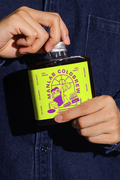 glass bottle mockup for cold brew coffee with label design, hand-held product presentation