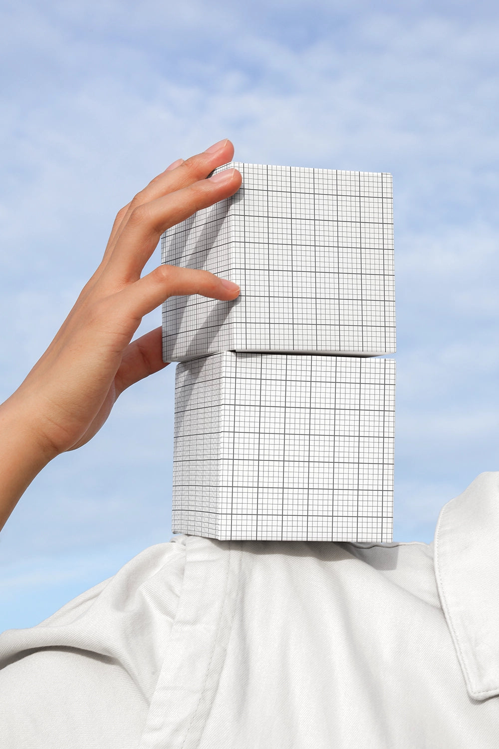 Packaging mockup with cube boxes in lifestyle scene with natural light sky background