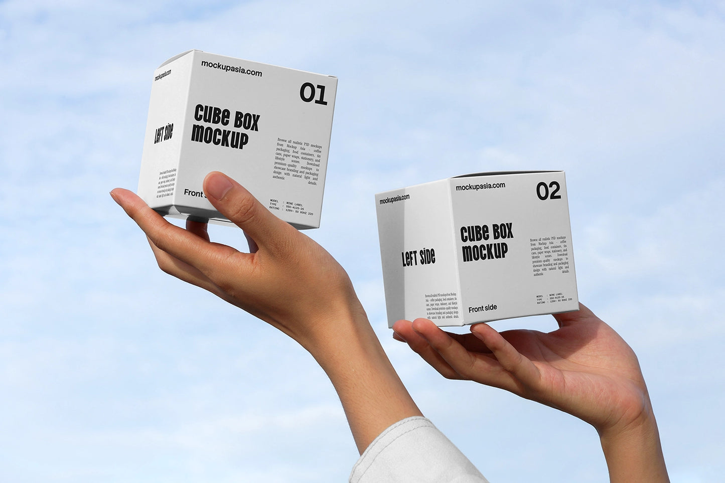 Cube box mockup with two packaging boxes held in hands against blue sky background
