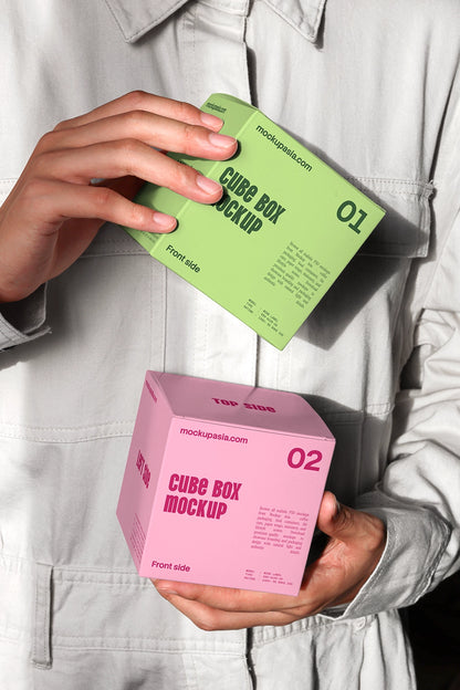 Minimal cube packaging mockup with handheld boxes and high contrast lighting