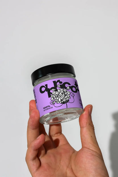 coffee jar packaging mockup with label design held by fingers, clean minimal lighting setup