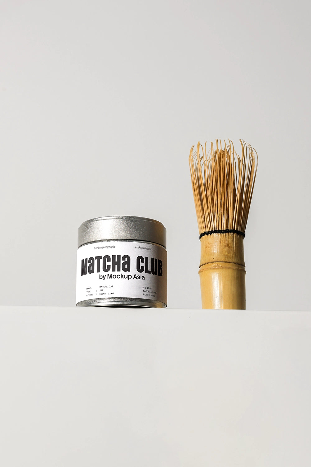 matcha tin can mockup with bamboo whisk, minimal product display on clean background