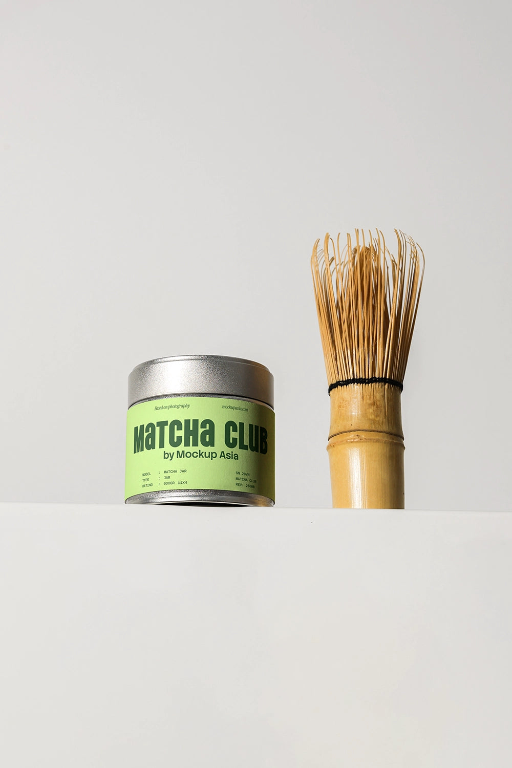 matcha packaging mockup with metal tin and whisk, simple and modern branding scene