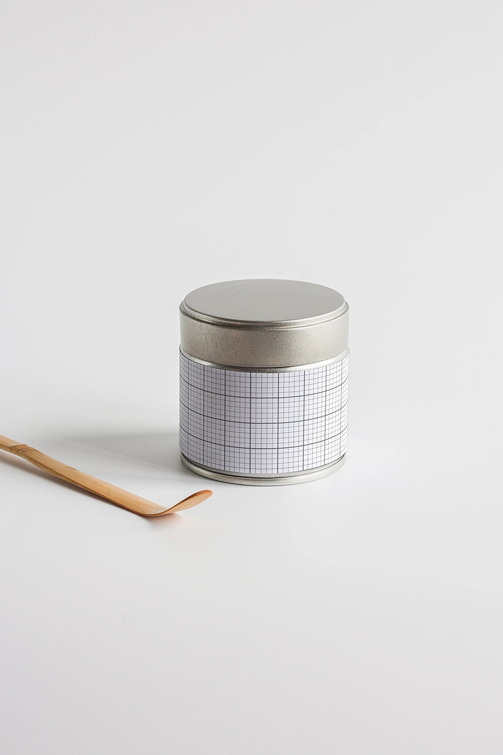 tea tin container mockup with wooden spoon on white background, simple branding setup
