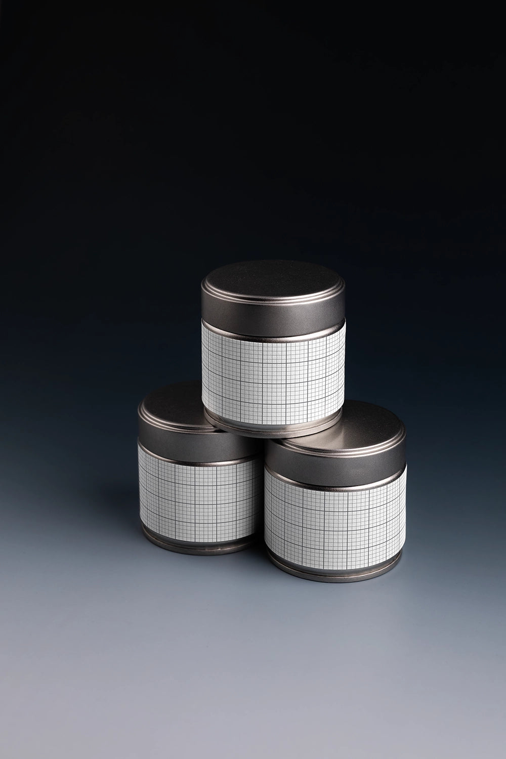 tea tin can mockup set with dramatic lighting, modern product branding display