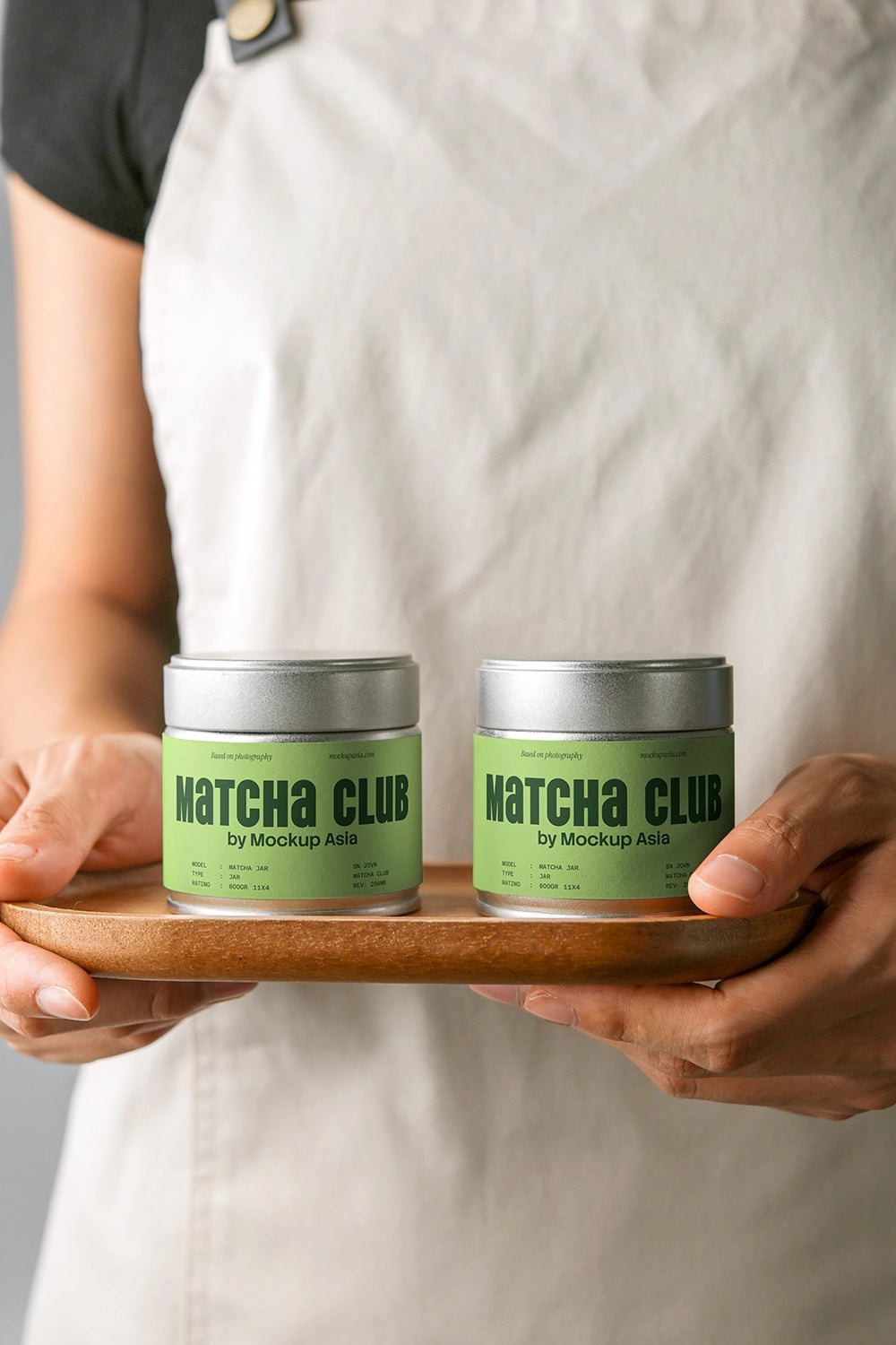 matcha packaging mockup with two tin containers on tray, realistic hand-held branding scene