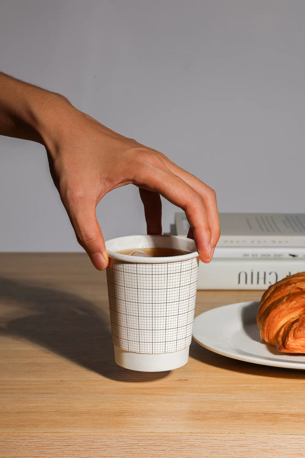 coffee cup mockup with logo design on table, warm lighting and food context