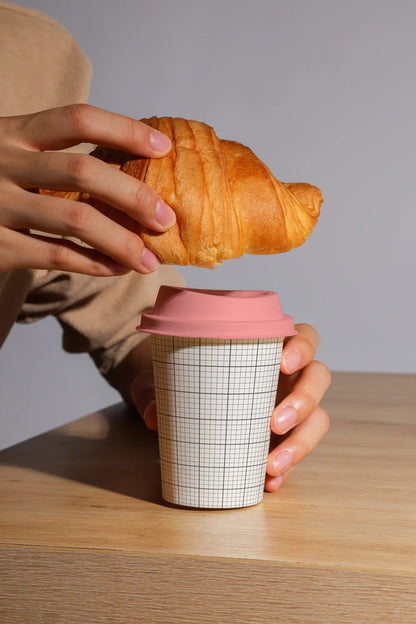 takeaway coffee cup mockup with croissant and hand interaction, natural lighting setup