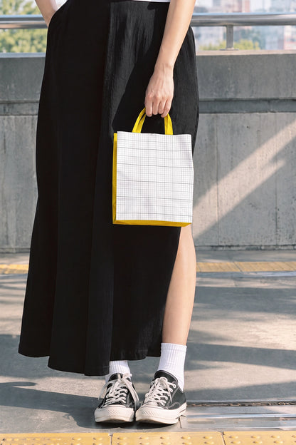 Paper bag mockup with editable accent color on concrete train station