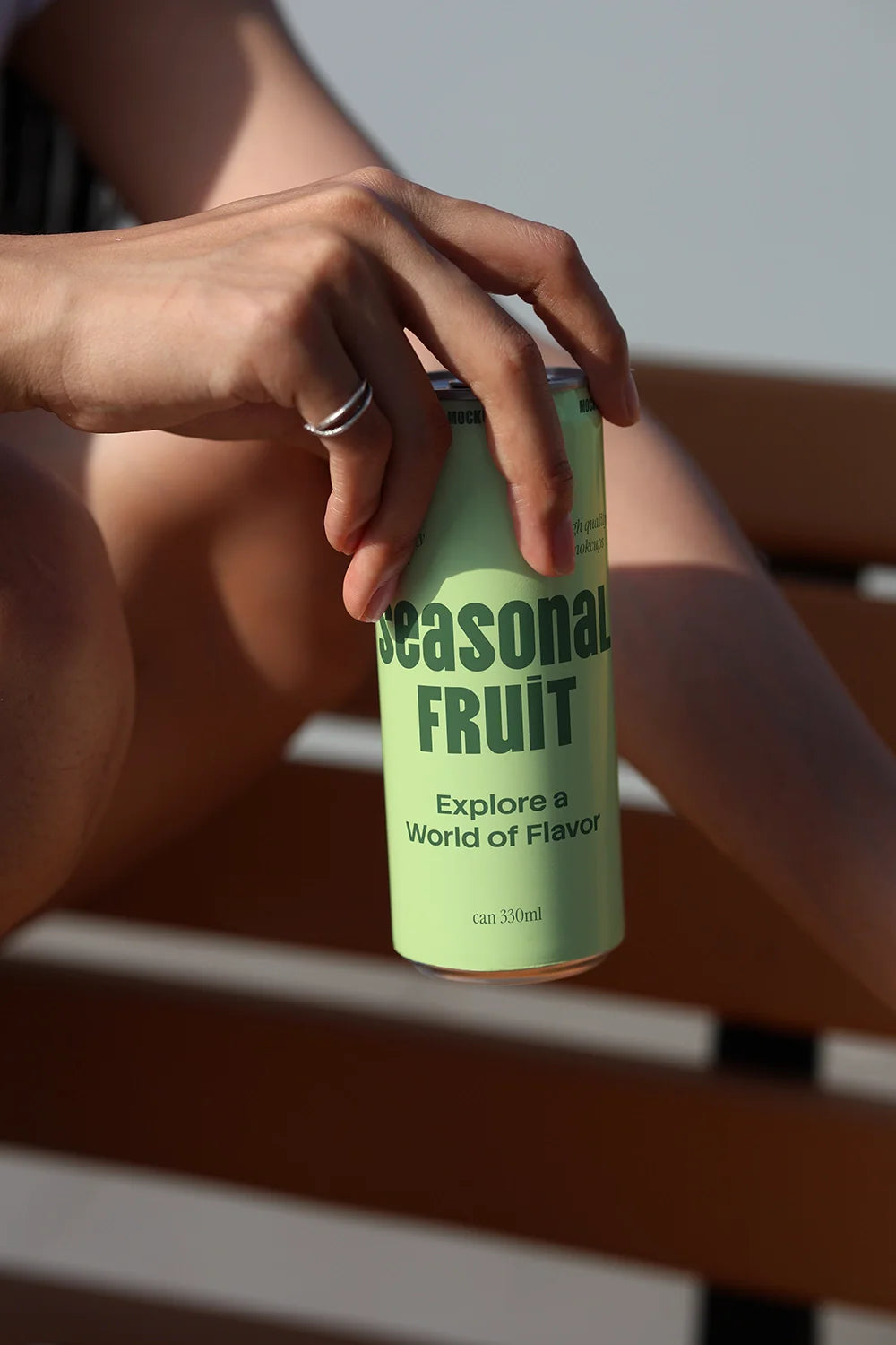 energy drink can mockup seated outdoor sunlight composition