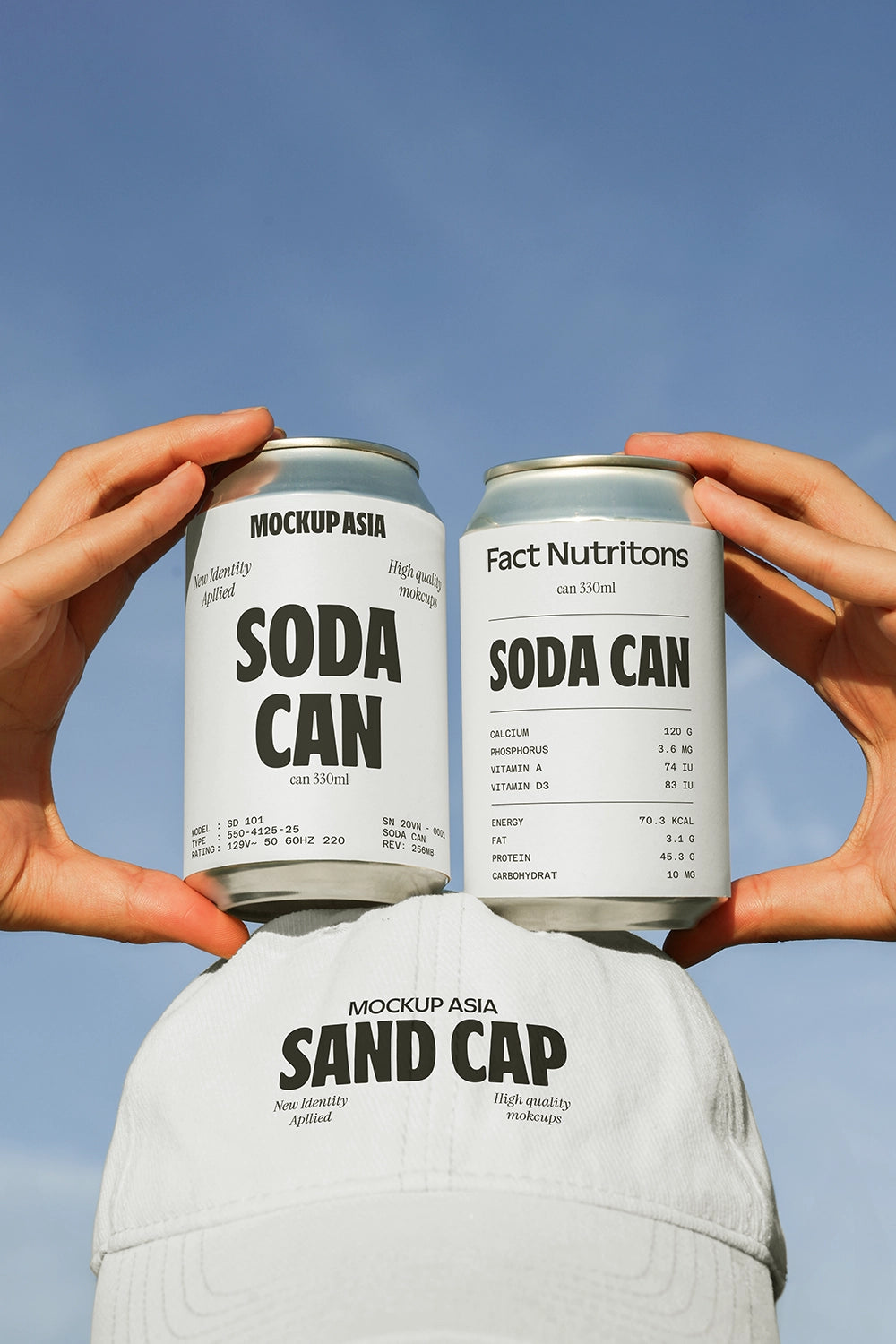 Two soda cans mockup held in hands above hat outdoor sky lifestyle aluminum beverage packaging