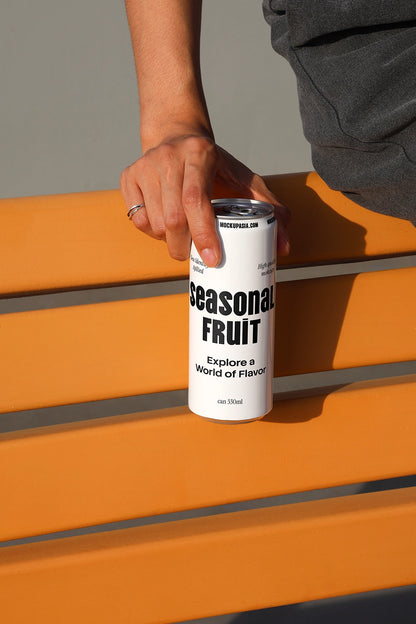 Minimal soda can mockup on orange bench with hand holding aluminum can in natural sunlight