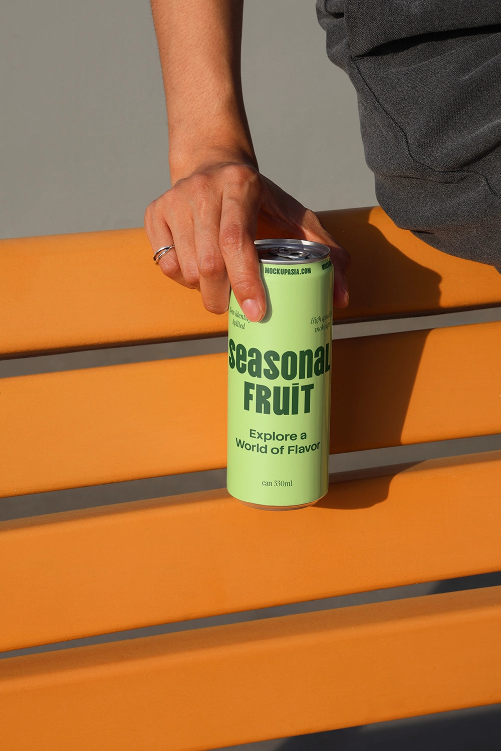 Beverage can mockup with clean outdoor bench background for soda and energy drink packaging design