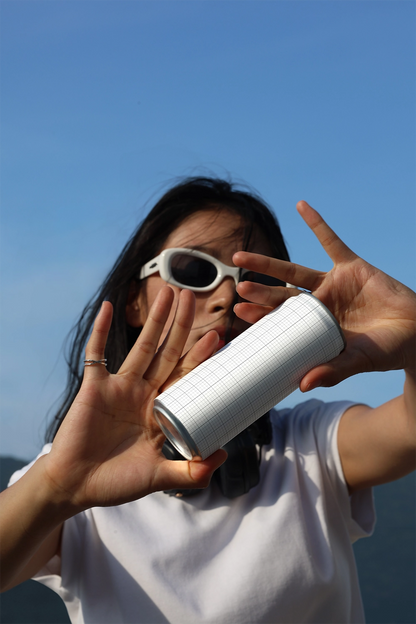 Creative soda can mockup with person holding can outdoors for energy drink and juice packaging design