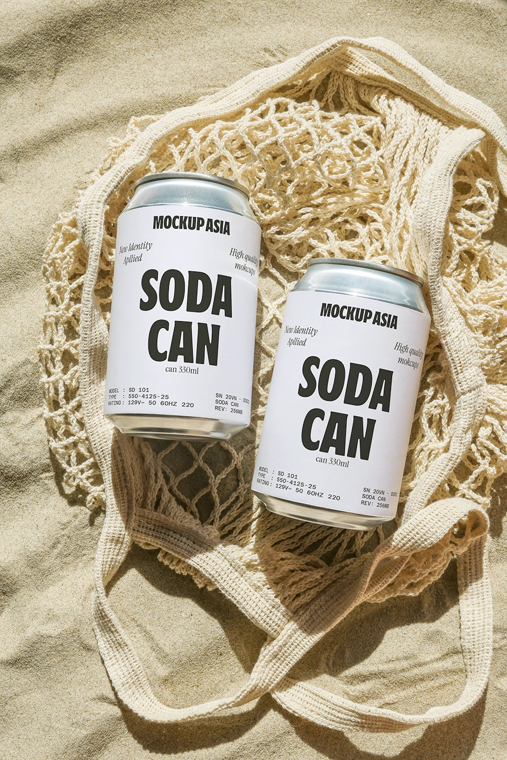 Soda can mockup on sand inside woven bag with natural beach lighting and summer lifestyle scene