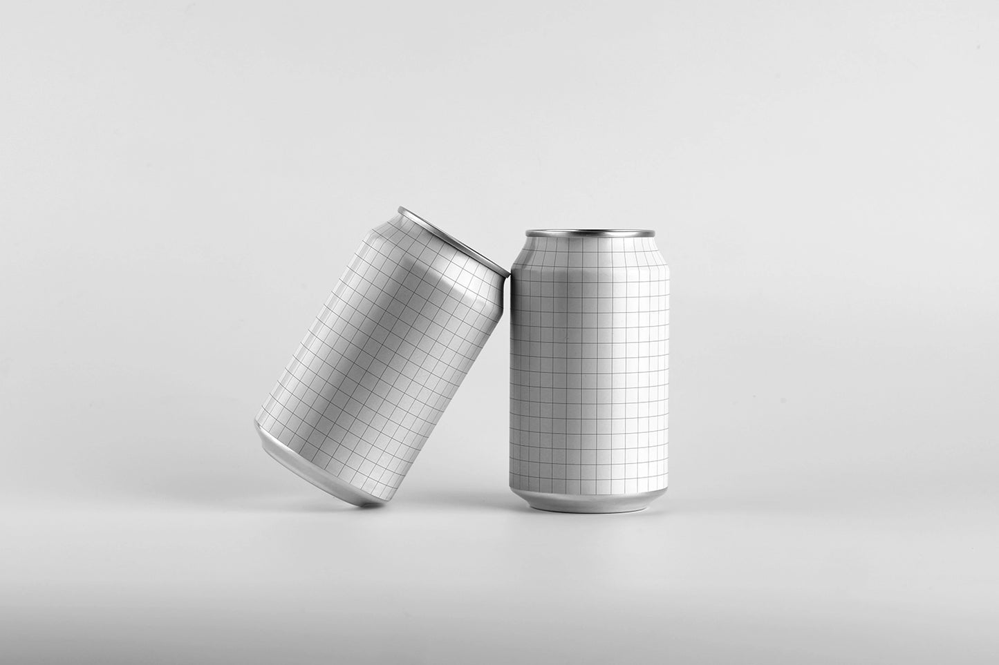 Blank beverage can mockup pair with dynamic tilt composition soft shadow clean white background