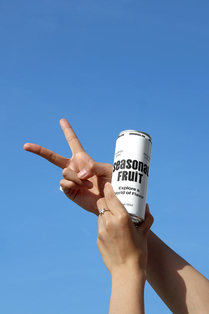 soda can mockup held in hand with blue sky background